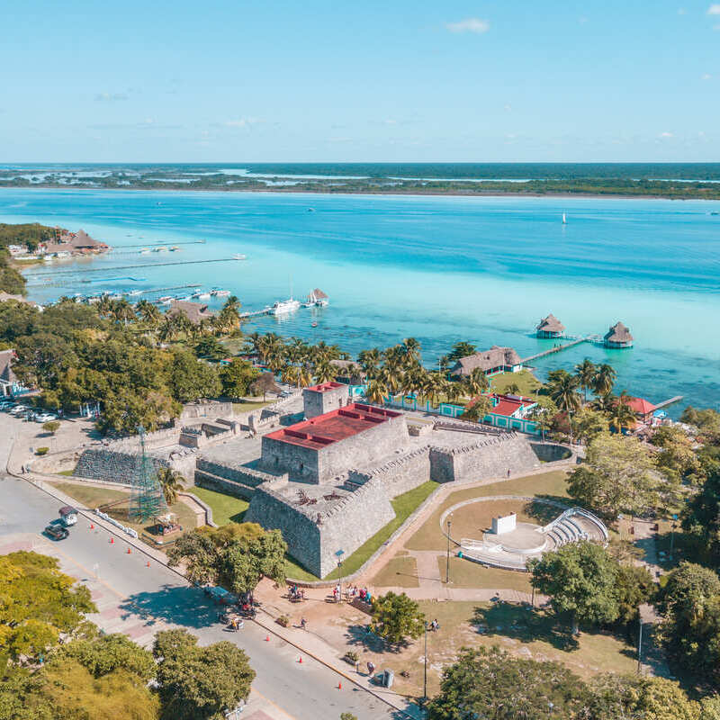 Aerial View Of Bacalar Town And A Spanish Era Fort, Straddling A Crystal Clear Lake Bacalar, In Southern Quintana Roo, Mexico