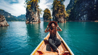 Happy Young Female Traveler Enjoying A Long Tail Boatride In Thailand
