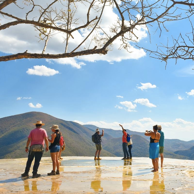Tourists during the day at Hierve el Agua "the water boils" is a set of natural rock formations in the Mexican state of Oaxaca that resemble cascades of water in Oaxaca de Juárez, Oaxaca, Mexico.