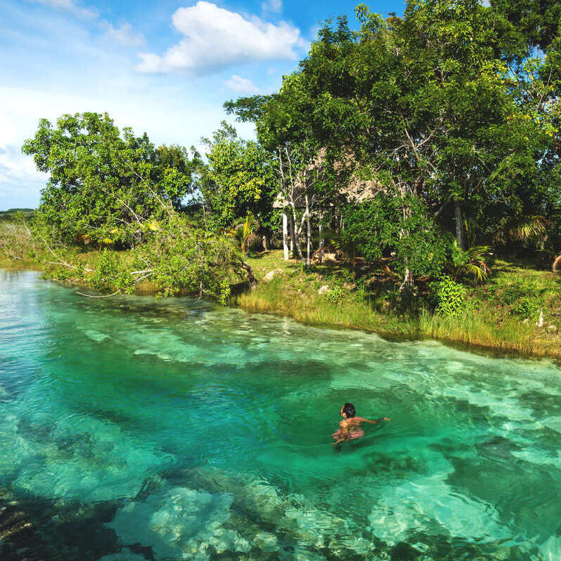 Male Tourist Swimming In Lake Bacalar, Southern Quintana Roo, Mexico