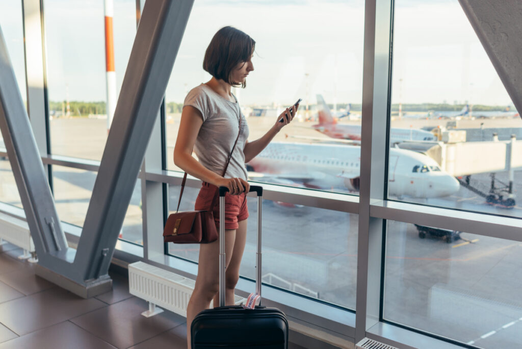 Woman Checking Phone at Airport