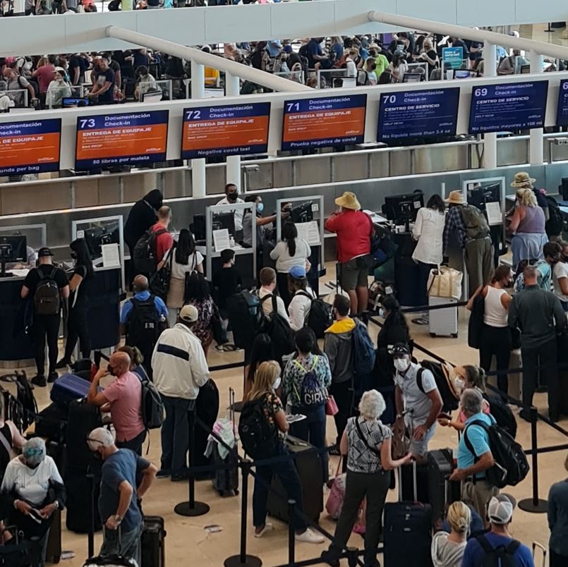 Travelers in long lines at cancun international airport