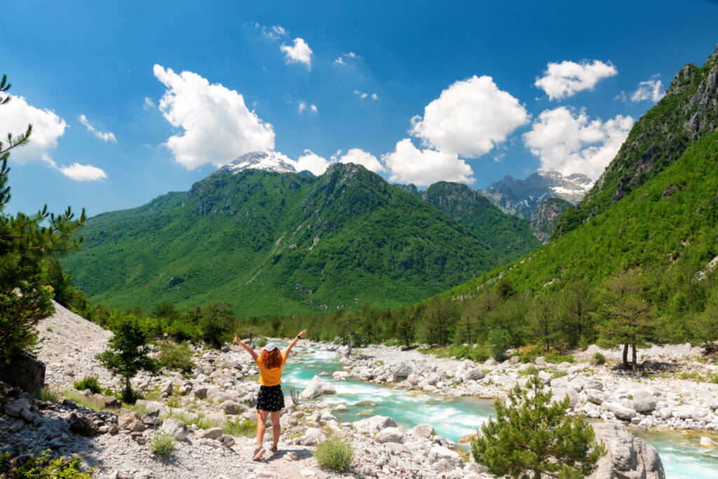 Woman standing in front of mountains in Northern Albania