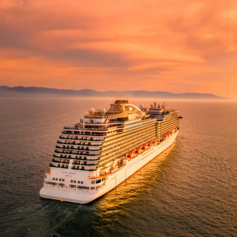 A Princess Cruise ship sailing off the coast of Mexico at sunset