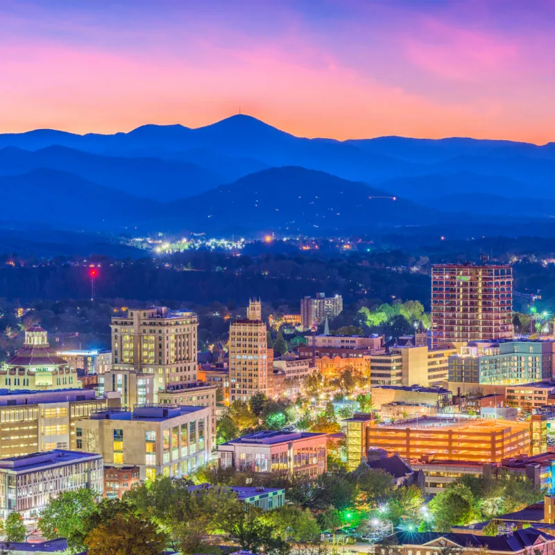 Asheville, North Carolina, USA skyline over downtown with the Blue Ridge Mountains.