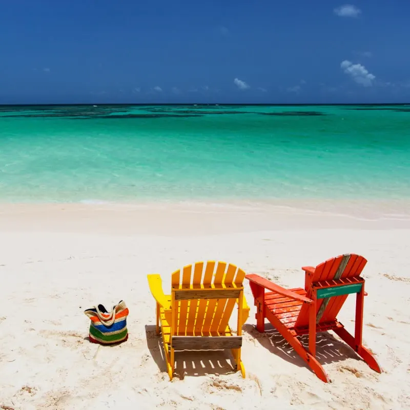 colorful chairs on pristine white beach in us virgin islands