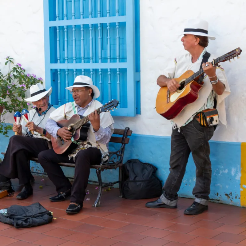 Colombian Musicians outside a colorful building in Medellin