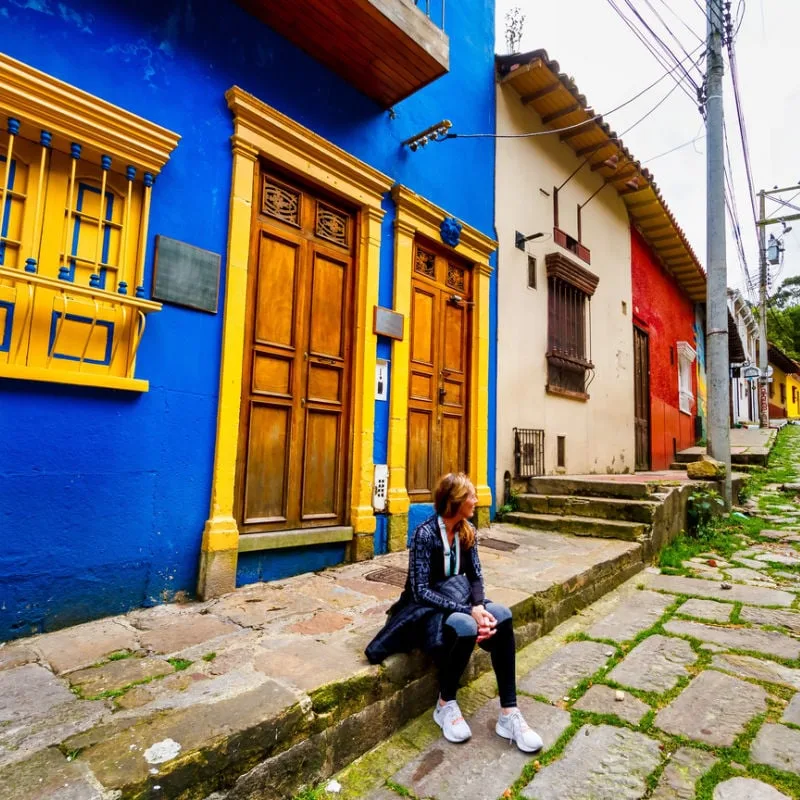 female tourist on cobbled street colombia