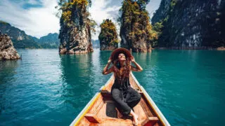 Happy Young Female Traveler Enjoying A Long Tail Boatride In Thailand