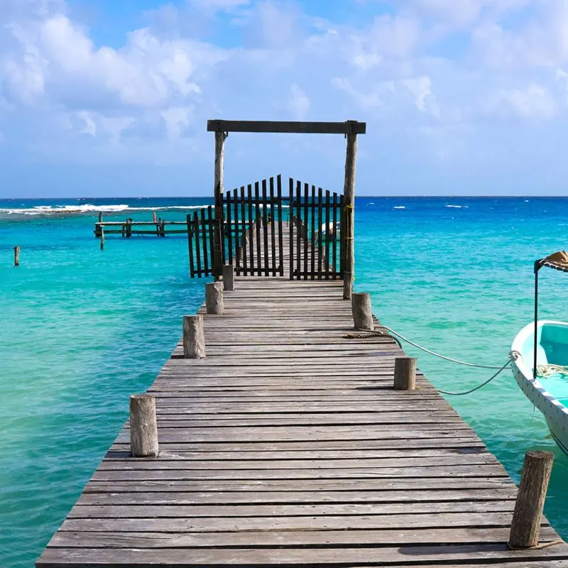 A Pier Stretching Out Onto The Sea In Mahahual, A Caribbean Beach In Southern Quintana Roo, Mexico