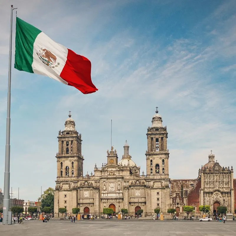 Mexico City Flag Flying In Front Of A Cathedral In Mexico City, Mexico