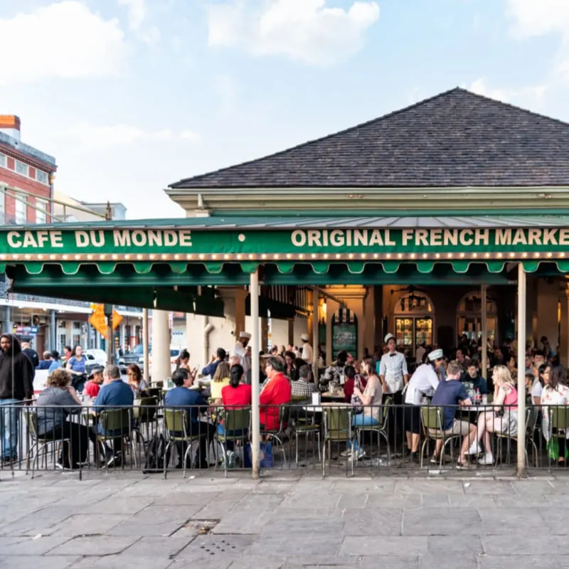 People sitting at tables at iconic Cafe Du Monde restaura