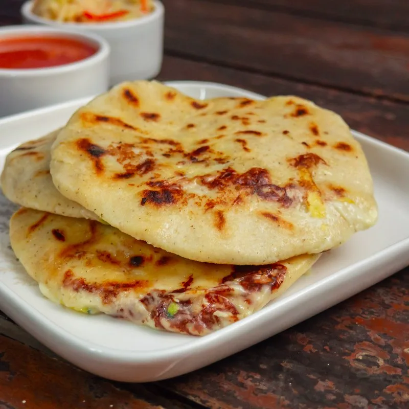 Typical delicious flour tortillas with cheese and beans from El Salvador, pupuseria, pupusa.