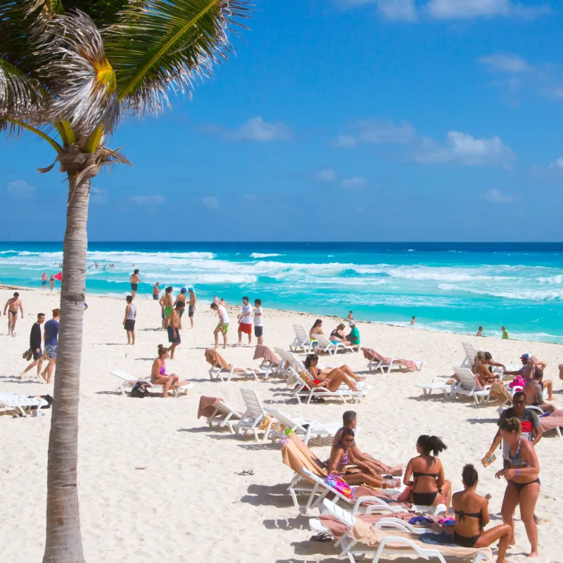beachgoers in cancun get some sun