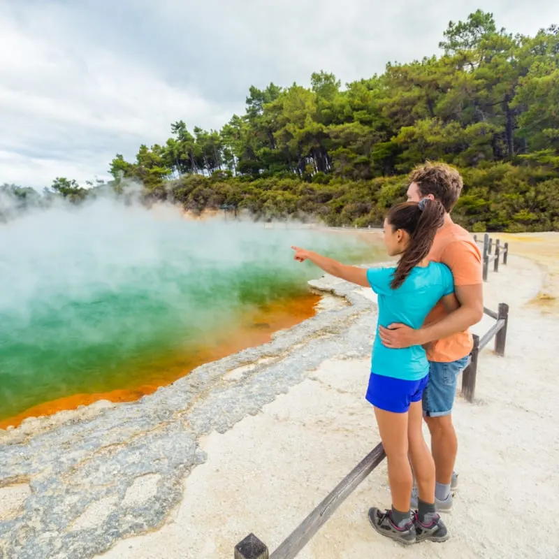 two tourists at waiotapu geothermal park in rotorua new zealand
