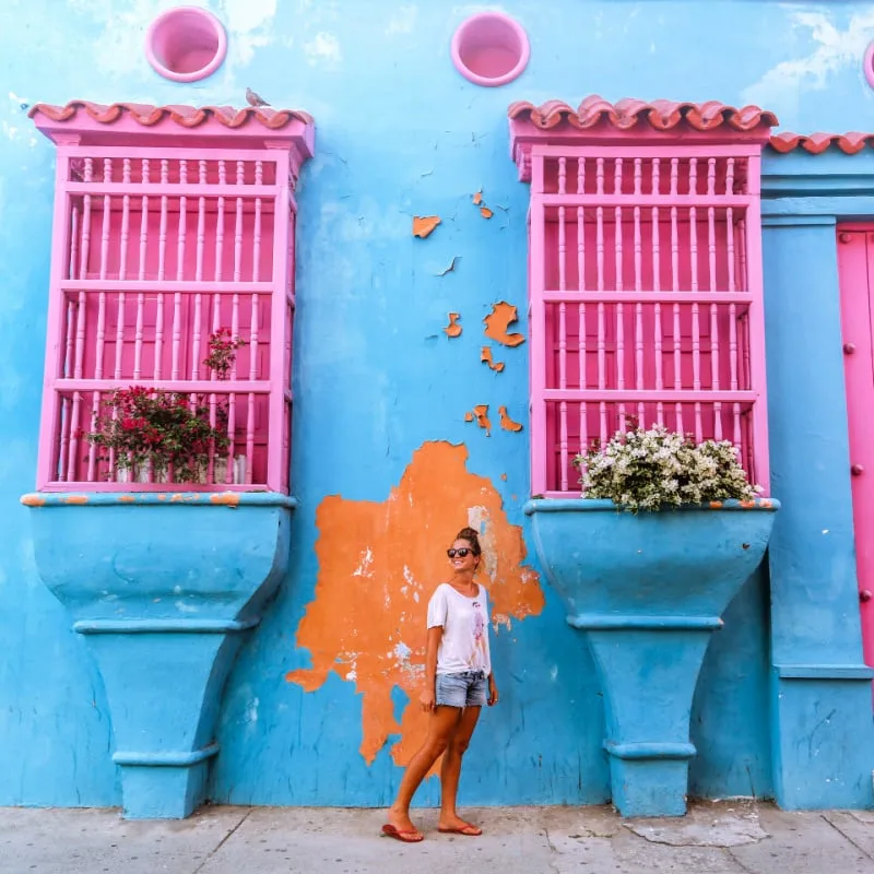 Woman standing in front of Colorful walls in Cartagena, Colombia