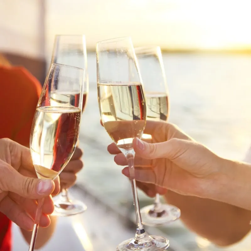 Toasting champagne on a cruise ship at sunset